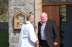 Rathlin's oldest parishioner Johnnie Currie welcomes the Bishop to St Thomas's.